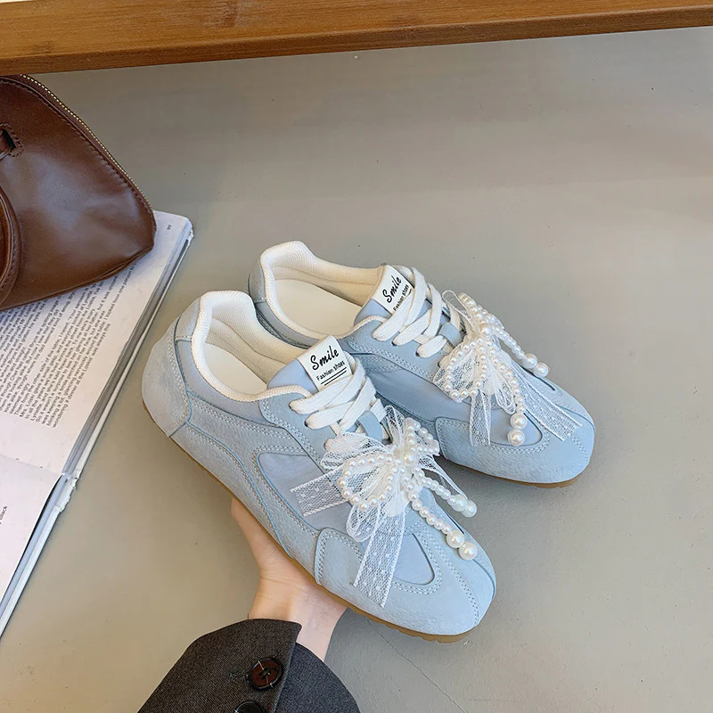 Damen Sportliche Sneakers mit elegantem Schleifendetail Heidi Mode